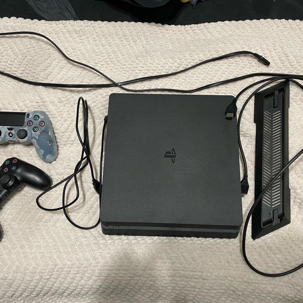 Sony PlayStation 4 Console with Black and Gray Controllers